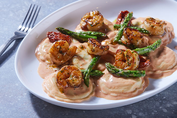 Celentano Garlic Florentine Ravioli with Black Tiger Shrimp, Fresh Asparagus and Sun-Dried Tomatoes in a Brandy Tomato Cream Sauce