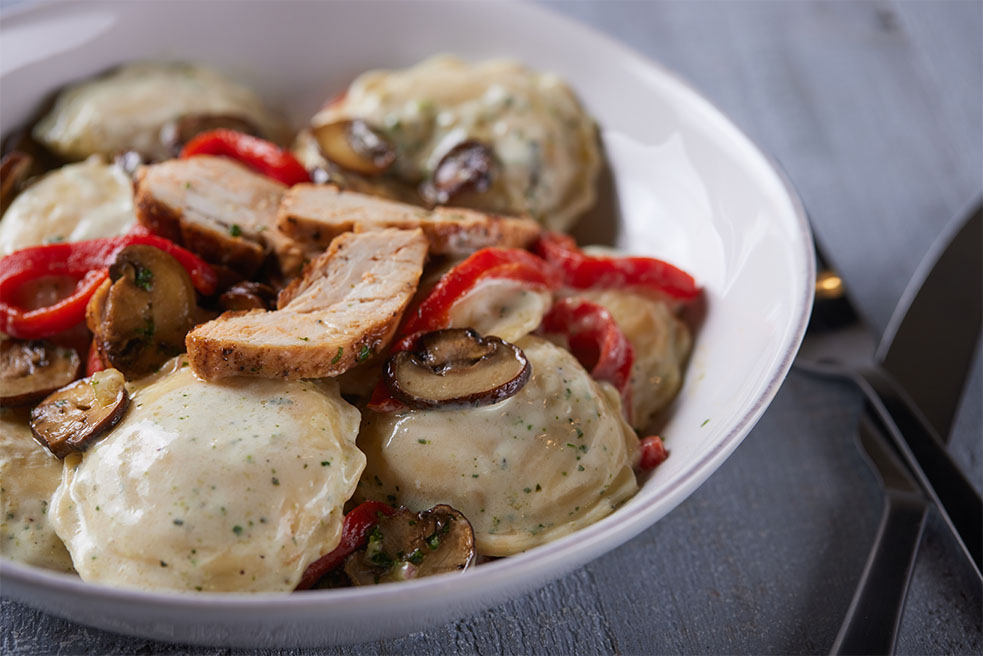 Celentano Four Cheese Ravioli with Grilled Chicken, Cremini Mushrooms and Roasted Red Peppers in Basil Cream Sauce