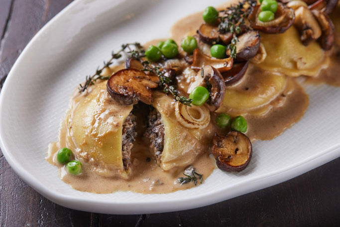 Celentano Portobello Mushroom Ravioli with Spring Onion, Peas, and Garlic Cream Sauce