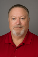 Doug headshot 2 headshot of man in red shirt